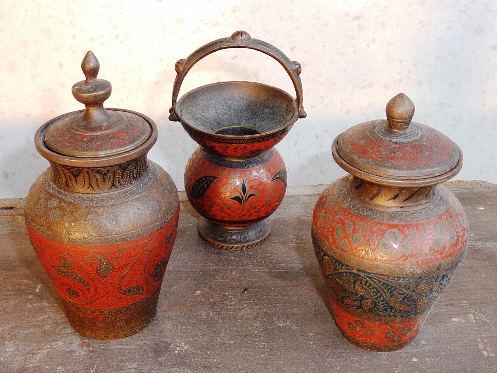 A garniture of three early 20th Century Indian enamelled brassware Vases and open Vessel with