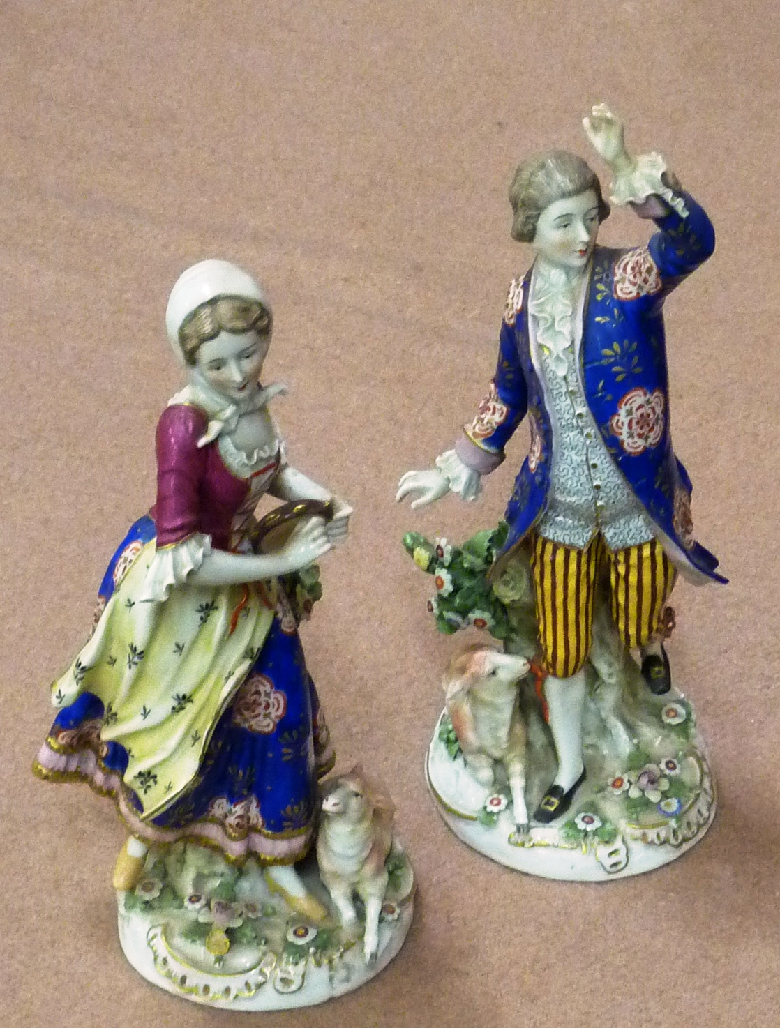 A pair of 19th Century hand decorated Continental porcelain Figure Models, male and female in 18th