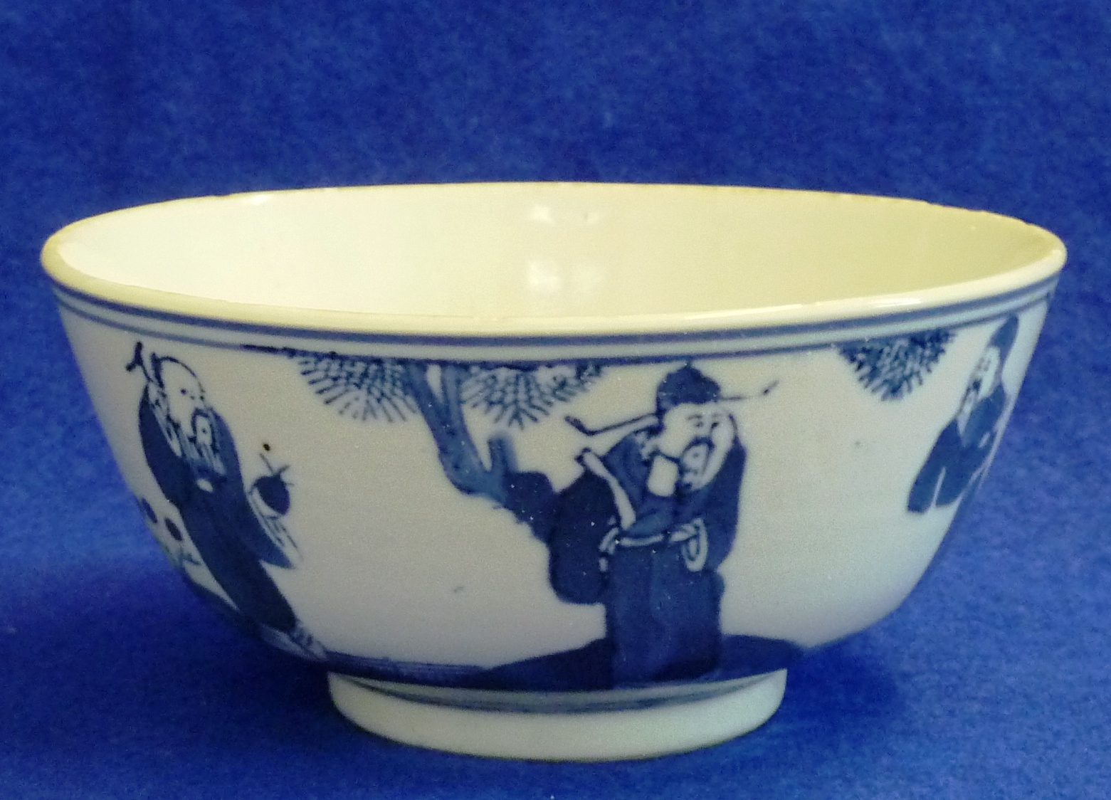 A Chinese porcelain Bowl decorated with three figures in a garden landscape with a pine tree, 11.