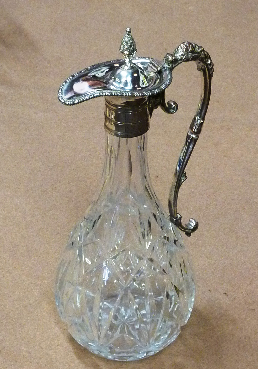 A 19th Century style cut glass and silver plated mounted Claret Jug having pineapple style finial