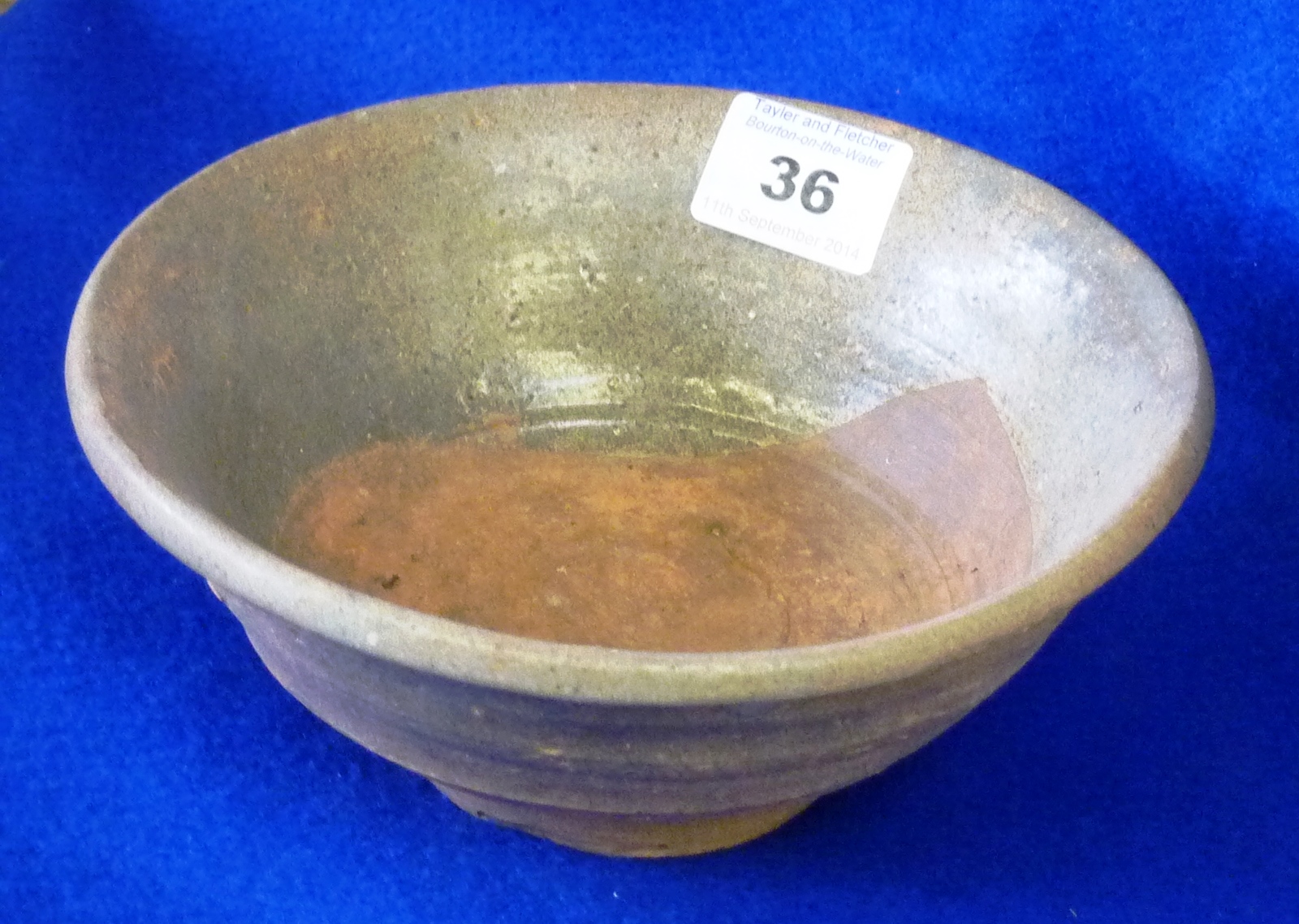 Song Dynasty (960-1279) deep footed Bowl with green glazes and circular foot rim, unglazed