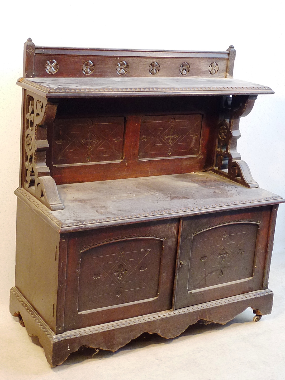 A late 19th Century aesthetic movement oak Sideboard in the style of Charles Bevan, galleried top