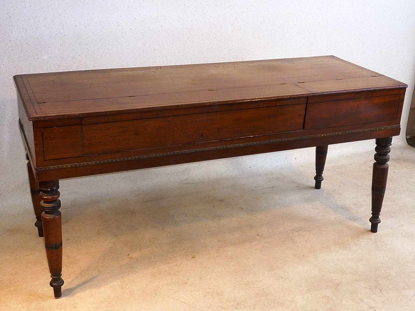 An early 19th Century mahogany and strung Spinette on four turned tapering legs (now as a Sideboard