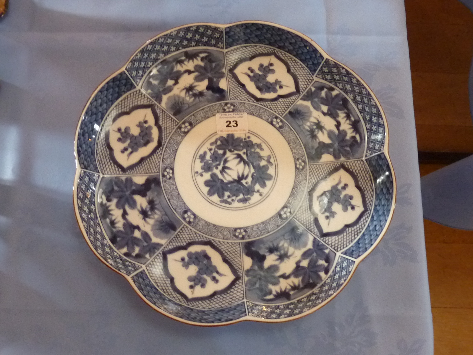A scallop edged Oriental porcelain Dish (probably Japanese), decorated with flowers and foliage