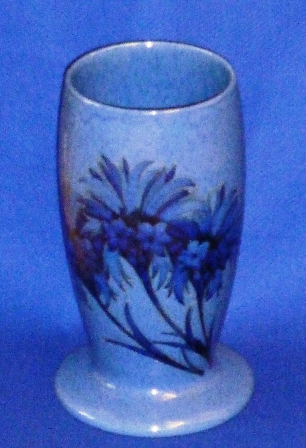 A rare early 20th Century Moorcroft Pottery Vase of circular baluster section decorated with blue