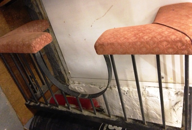 A large steel and upholstered Club Fender, the two upholstered seats flanking dipped front, 5'