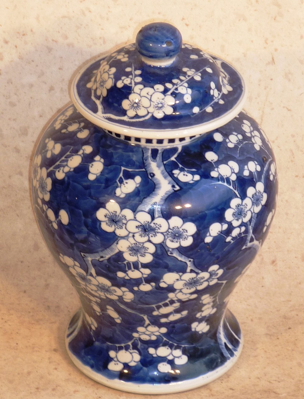 A 19th Century Kangxi style Chinese blue and white baluster shaped Vase and Cover hand decorated