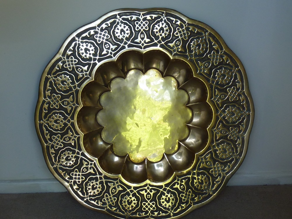 A large Benares style brass Table Top, foliated edge, hand hammered strapwork style decoration and