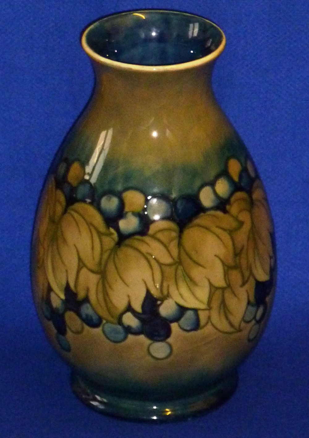 A large early 20th Century William Moorcroft Pottery baluster shaped Vase in the leaf and berry