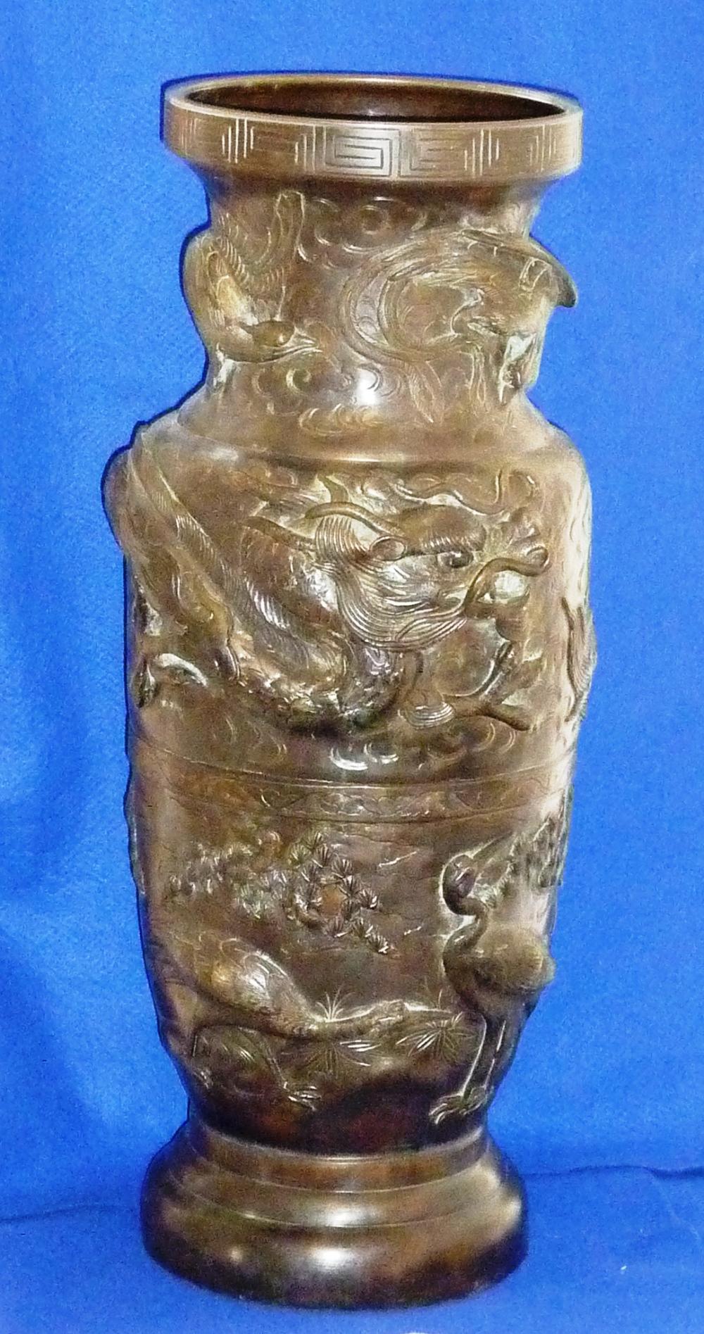 A massive Chinese baluster shaped patinated bronze Vase, the lip with a key fret border above two