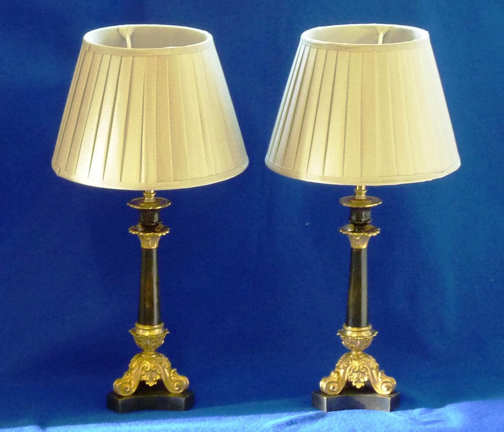 A pair of 19th Century (circa 1830) patinated bronze and ormolu mounted Candlesticks, the gilded