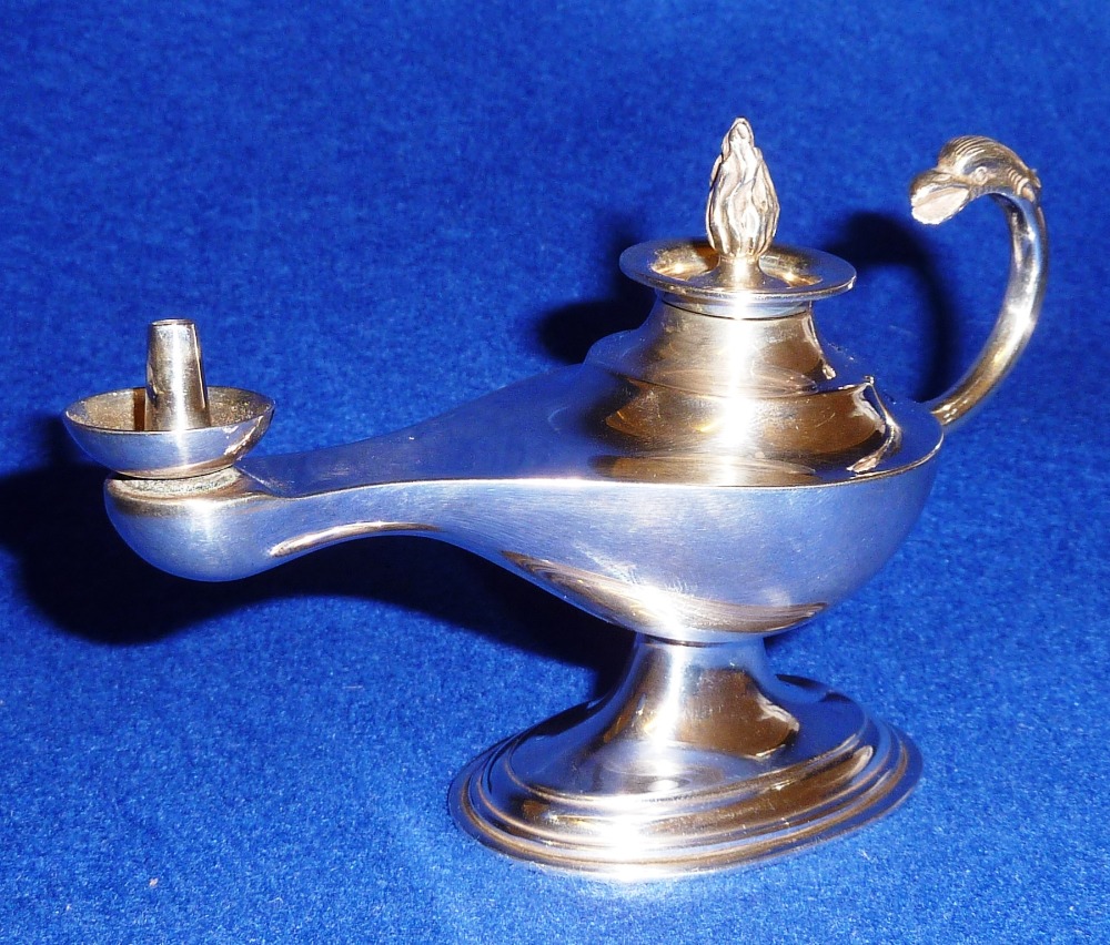An early 20th Century hallmarked silver novelty Table Lighter in the form of an early oil lamp,