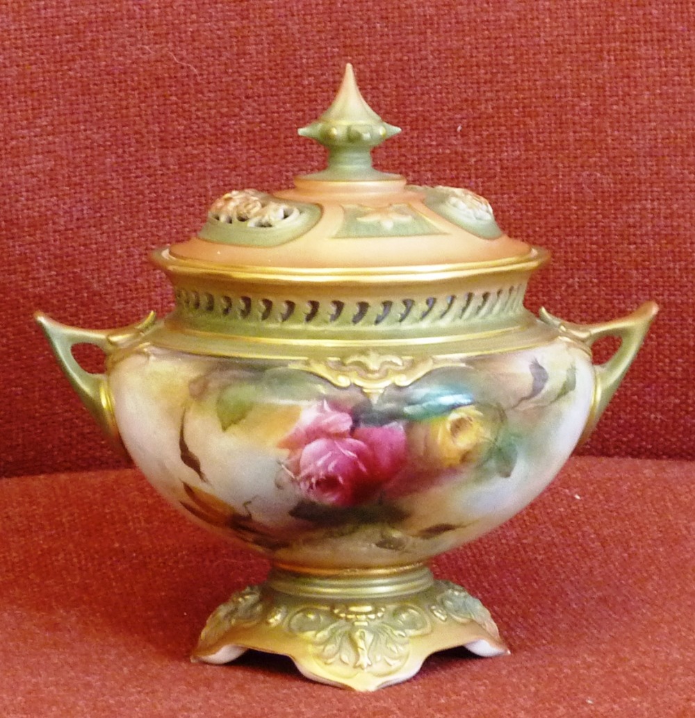 An early 20th Century Royal Worcester porcelain Pot Pourri, the spire shaped finial flanked by two