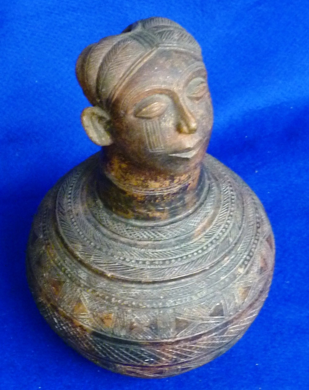 African Continent, an unusual patinated terracotta Flask, spherical main body surmounted by a head