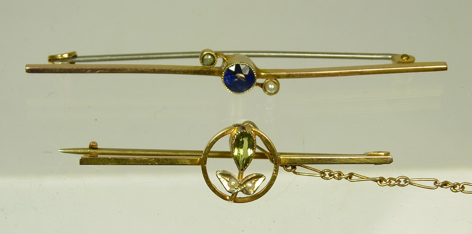 A 9ct gold bar brooch set with cut peridot and seed pearl set flower together with another 9ct gold