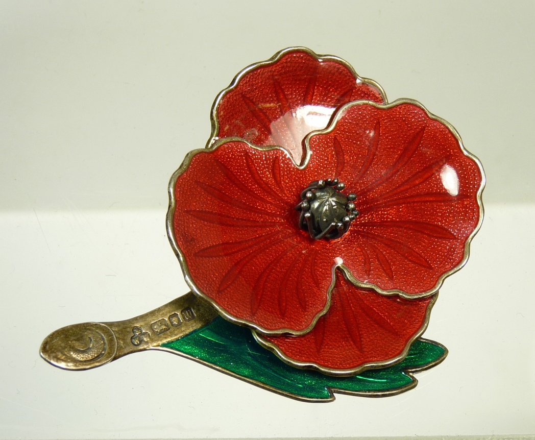 A silver and enamel poppy brooch, with London hall mark and maker ""W&W"" ++good