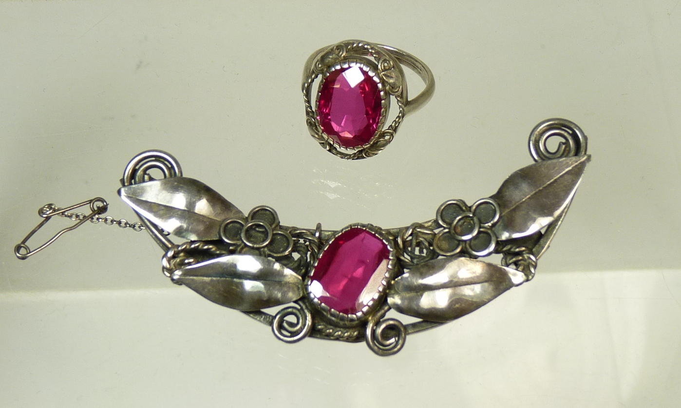 An Arts and Crafts style white metal and red stone brooch and ring (2)