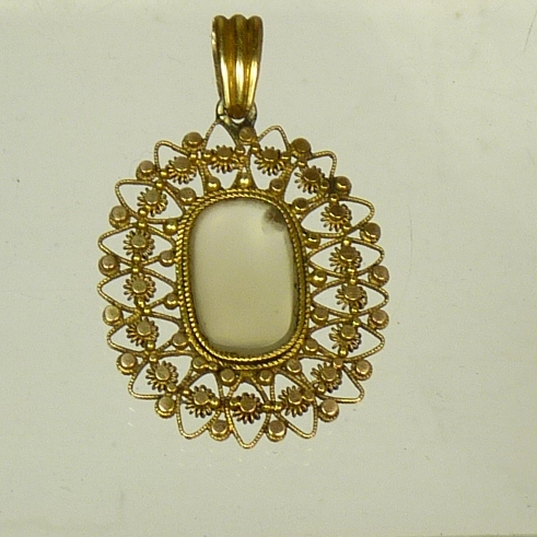 A Victorian openwork gold pendant centred with a clear hardstone panel, overall length 3.5cms,