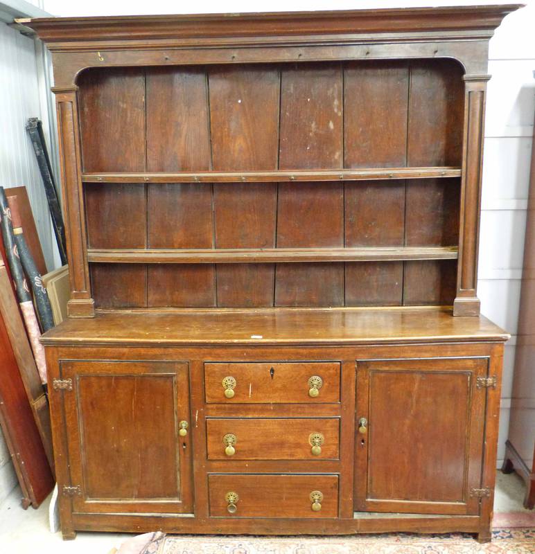 LATE 18TH CENTURY OAK DRESSER WITH 2 PANEL DOORS FLANKING 3 DRAWERS WITH SHELVES