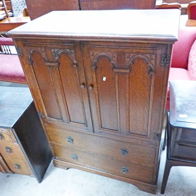 EARLY 20TH CENTURY OAK TALLBOY WITH 2 PANEL DOORS OVER 2 DRAWERS ON BRACKET SUPPORTS