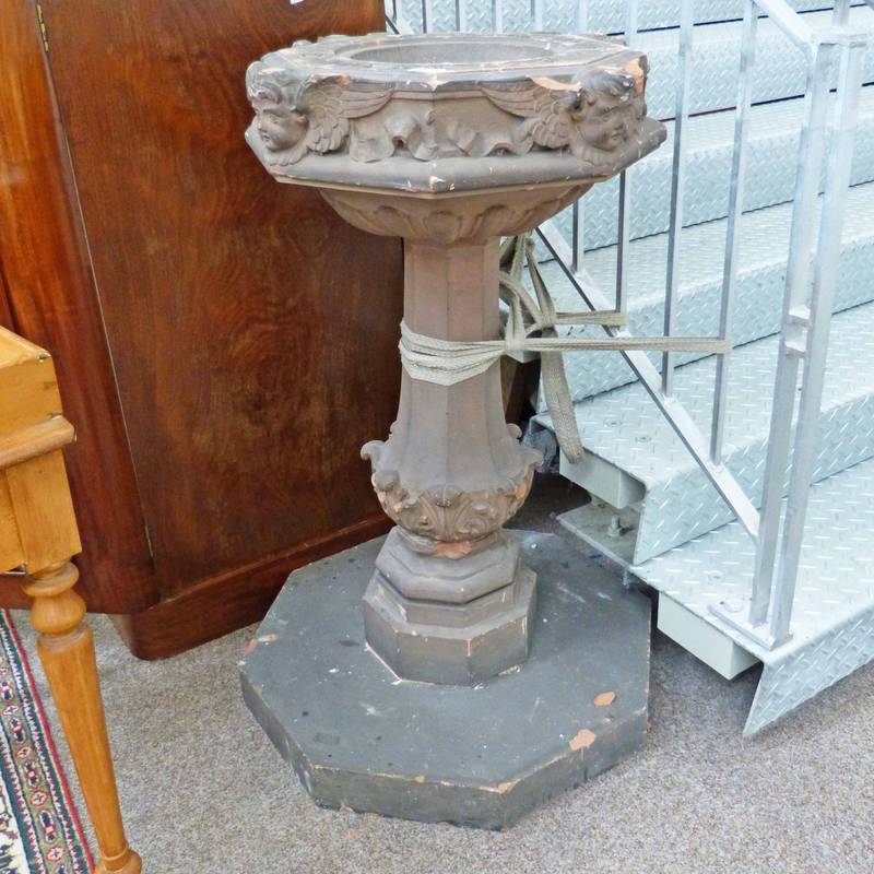 19TH CENTURY STONE FONT DECORATED WITH CHERUBS ON OCTAGONAL BASE