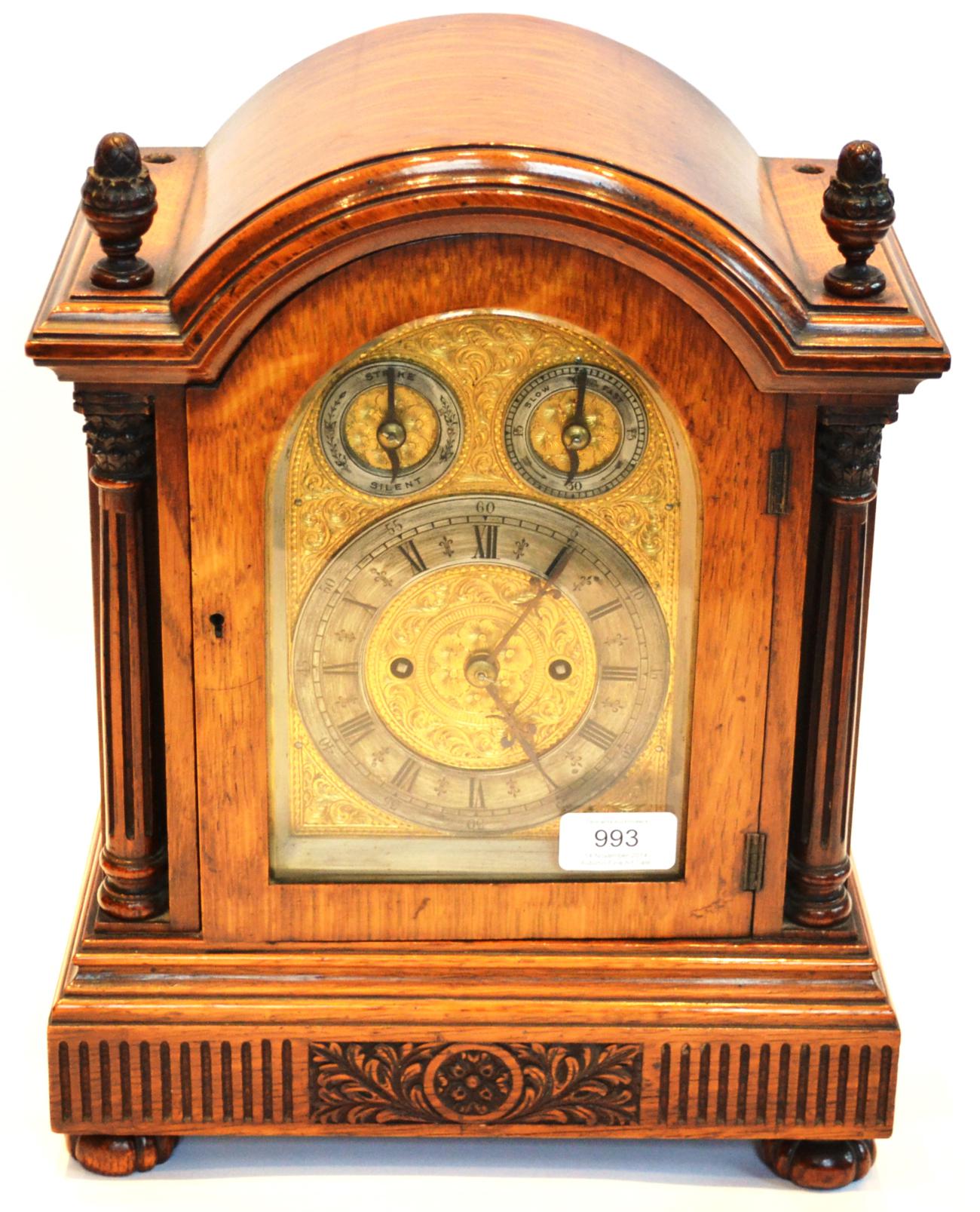 An Oak Striking Table Clock, circa 1890, arched top with carved finials, pierced side frets,