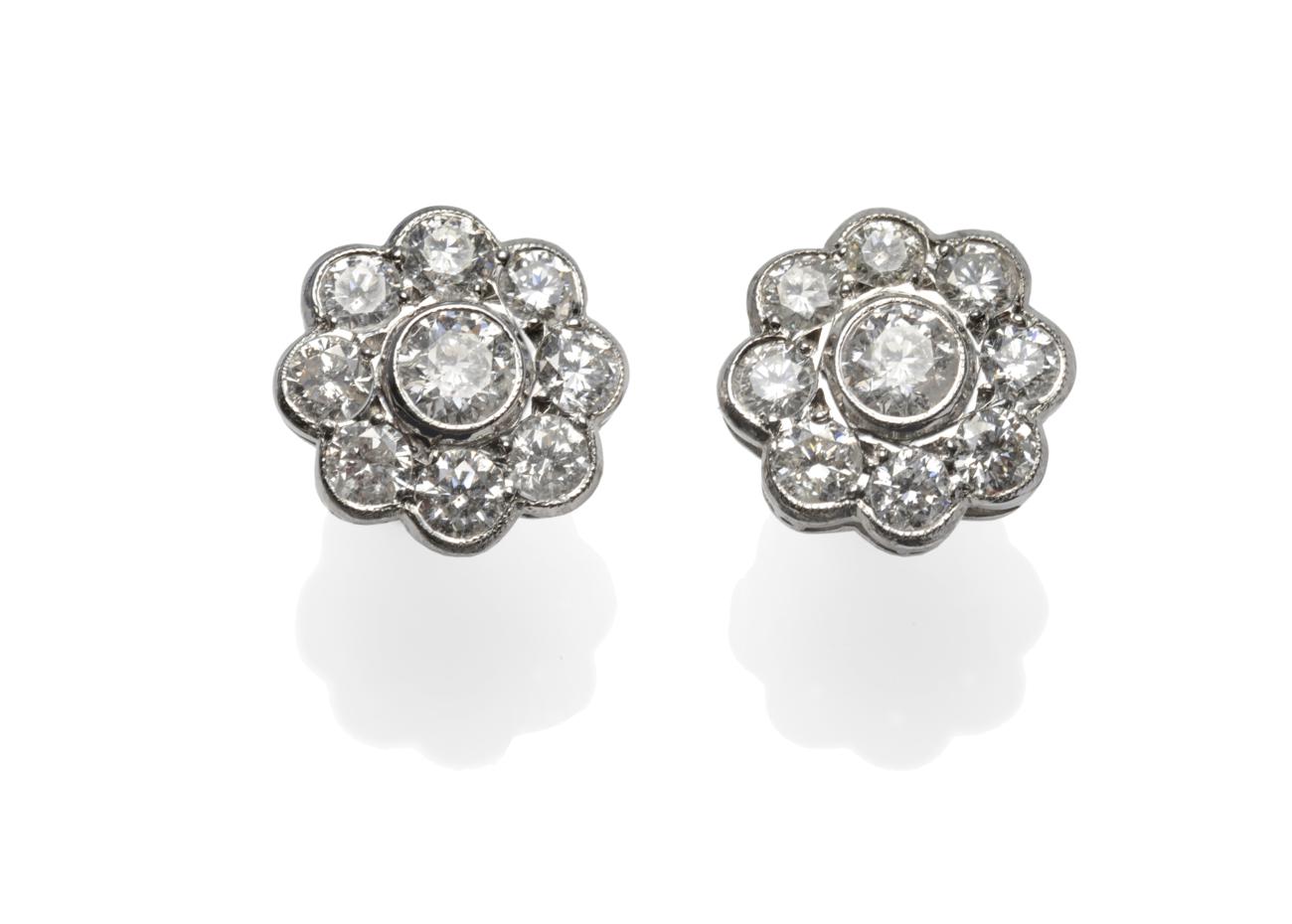 A Pair of Diamond Cluster Earrings, each comprising nine round brilliant cut diamonds in a circular