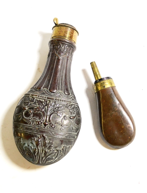 A 19th Century Copper Powder Flask, embossed with scrolling acanthus and vine leaves, with fluted