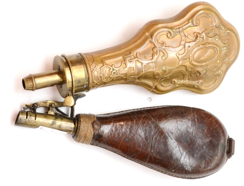 A 19th Century Copper Powder Flask, of violin shape, embossed with foliate strapwork, with brass