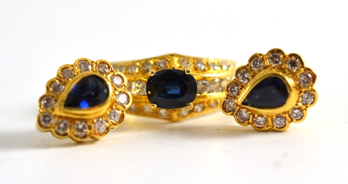 A sapphire and diamond ring, stamped `750` and a pair of pear shaped sapphire and diamond cluster