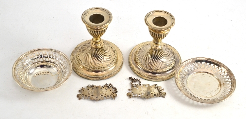 Pair of loaded silver dwarf candlesticks, pair of Victorian silver bottle labels and two small