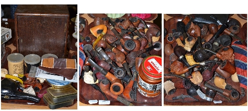 A large collection of pipe smoking equipment including a large number of pipes, cabinet, tobacco