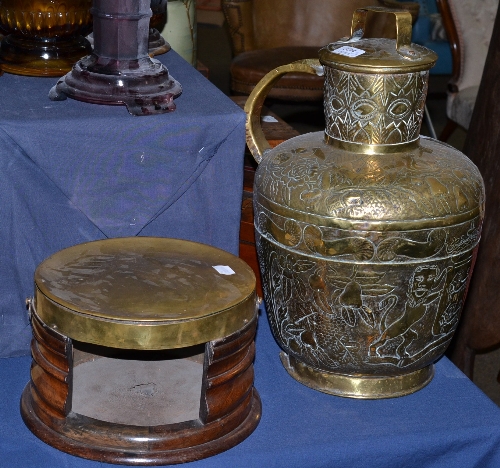 A brass mounted mahogany foot warmer, a large lidded jug embossed with lions and flowers and