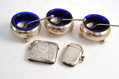 A set of three Victorian silver salts and spoons and two silver vesta cases