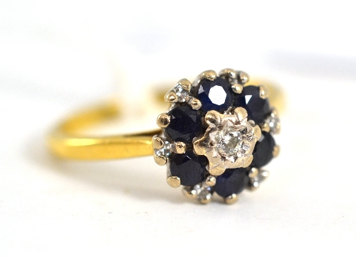 A diamond and sapphire cluster ring, stamped `18CT`