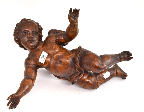 A carved wood figure of a cherub