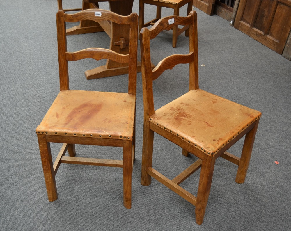 A Set of Four Kingpost Woodwork Oak Chairs, with shaped rail backs, on four square section legs