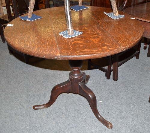 A George III oak flip top tripod table, 87cm diameter