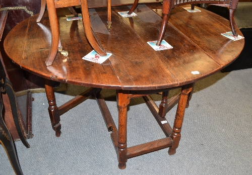 An 18th century elm gateleg table fitted with single frieze drawer, 129cm wide