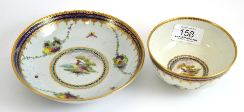 A First Period Worcester tea bowl and saucer, decorated with exotic birds, insects and fruit swags