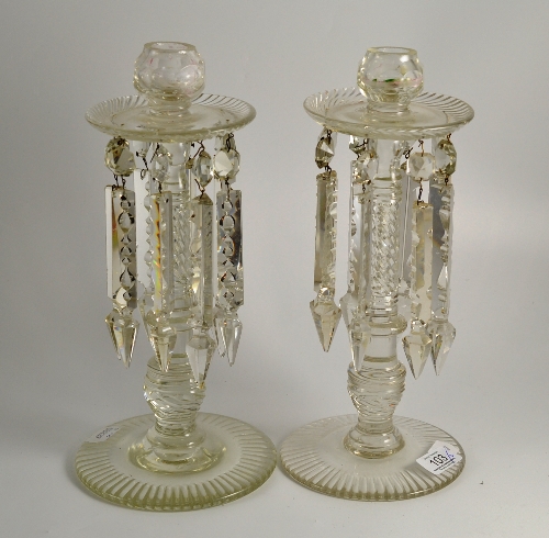 Pair of glass lustre candlesticks, 32cm high and a pair of glass candlestciks 24cm high