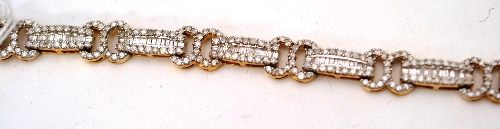 A 9ct gold fancy link diamond bracelet, the links with graduated baguette cut diamonds within