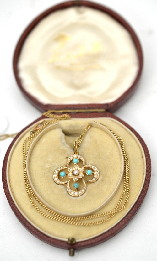 An early 20th century turquoise and pearl pendant, the stone set pendant in quatrefoil form,