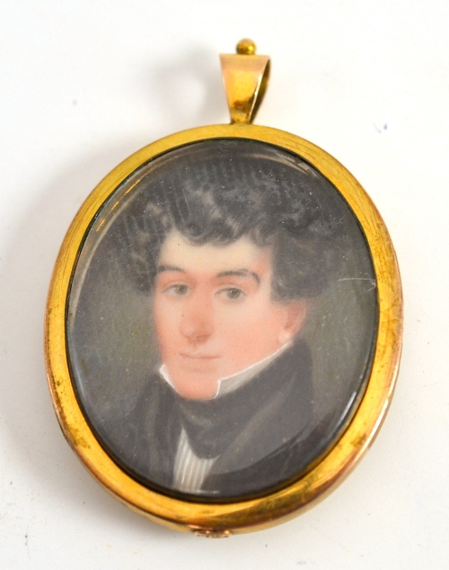 English School, circa 1800, portrait of a young man, wearing a dark coat, oval miniature on ivory,