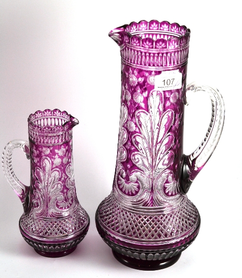 Two cut glass amethyst flash jugs, 34cm and 22cm