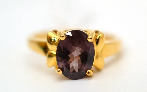 An 18ct gold alexandrite ring, the colour change stone in a yellow claw setting, finger size N1/2