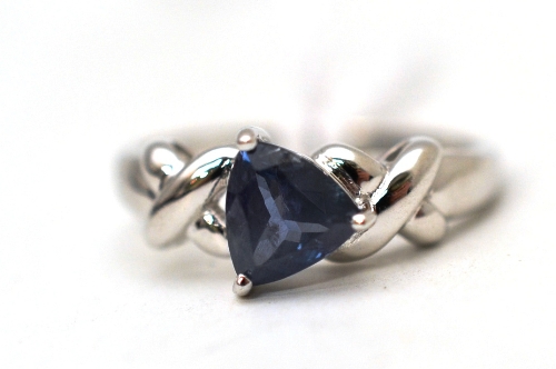 An 18ct white gold alexandrite ring, the trilliant cut alexandrite in a three claw setting, to