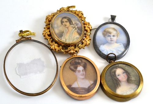 An early 19th century circular miniature portrait on ivory of a girl, her hair in ringlets,