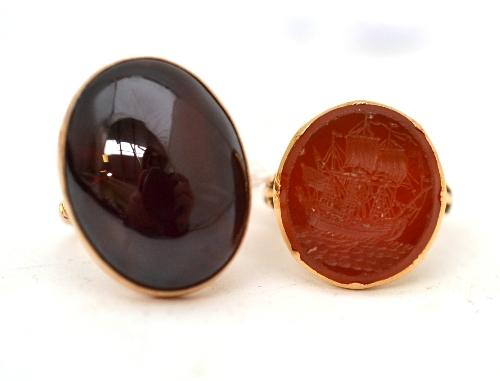 An intaglio ring with a cornelian carved as ship, finger size M approximately, and a carbuncle