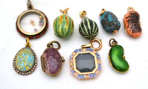 Nine enamelled and gem-set charms, including two modelled as fruits, two lockets, one with seed